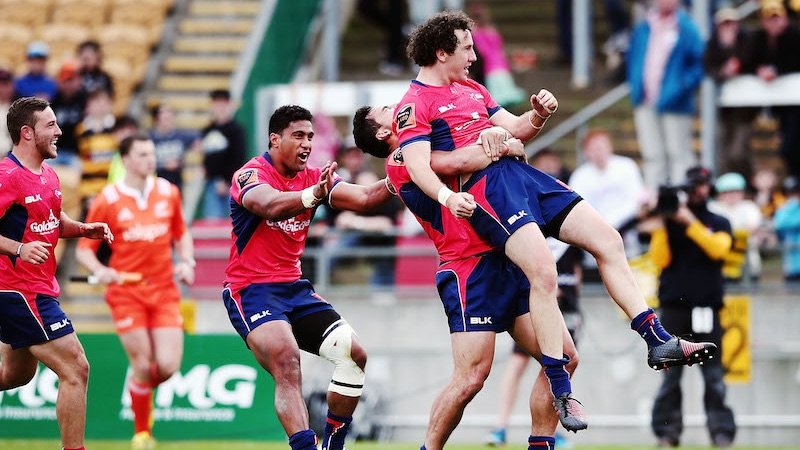 Marty Banks' Tasman teammates attempt to physically carry him to a hair salon. (Photo: Getty Images)