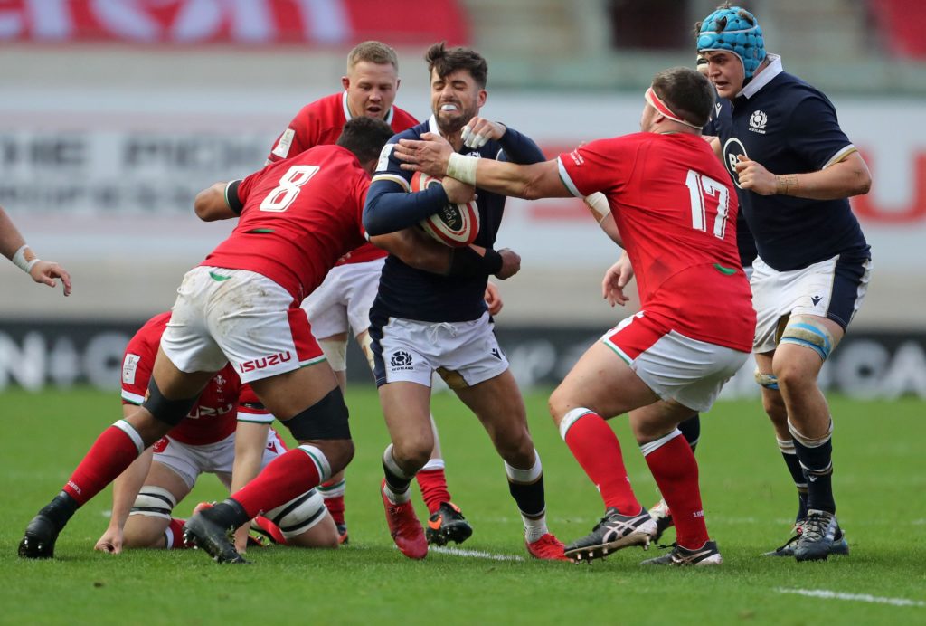 Adam Hastings takes on the Welsh defence