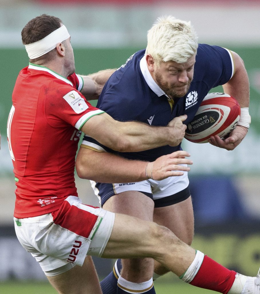 Oli Kebble of Scotland is tackled by Wales' Gareth Davies