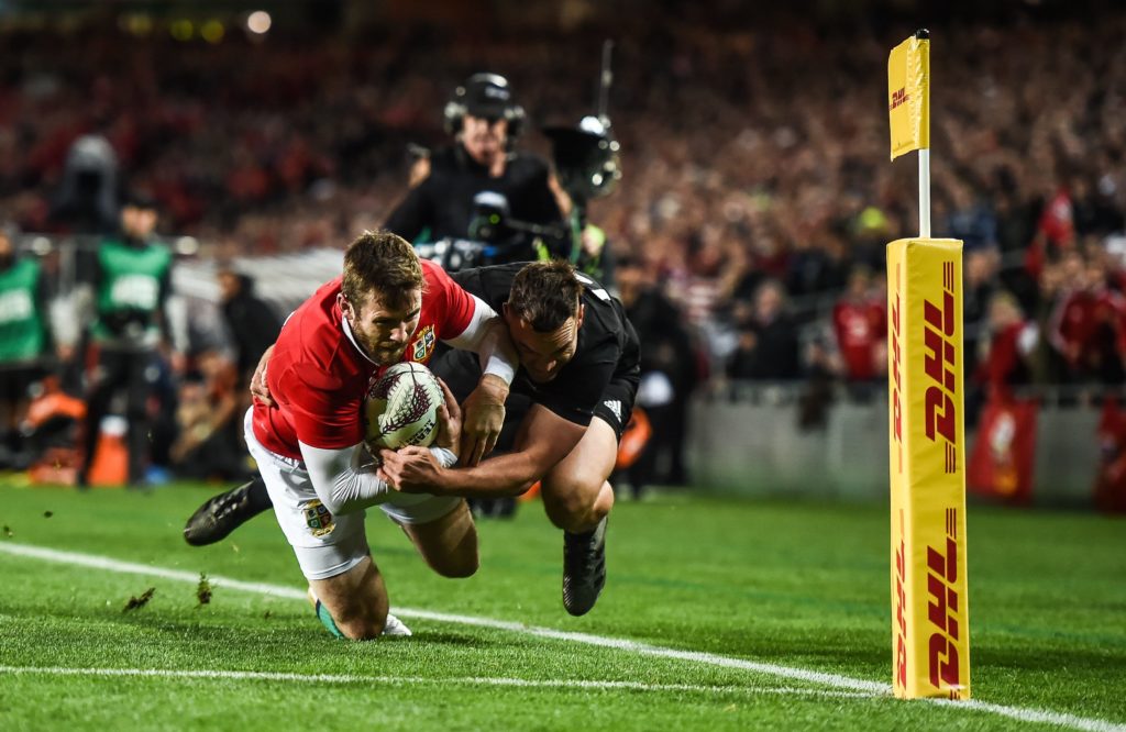 Elliot Daly of the British and Irish Lions is tackled by New Zealand's <a href=