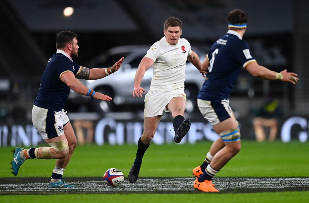 England's Owen Farrell kicks the ball through the Scottish defensive line at Twickenham