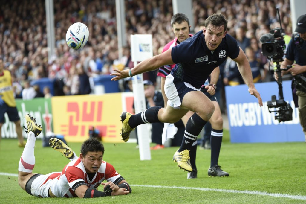 John Hardie of Scotland throws an offload against Japan