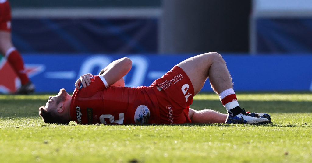 Johnny Williams lies in pain after injuring his shoulder on duty for Scarlets against <a href=